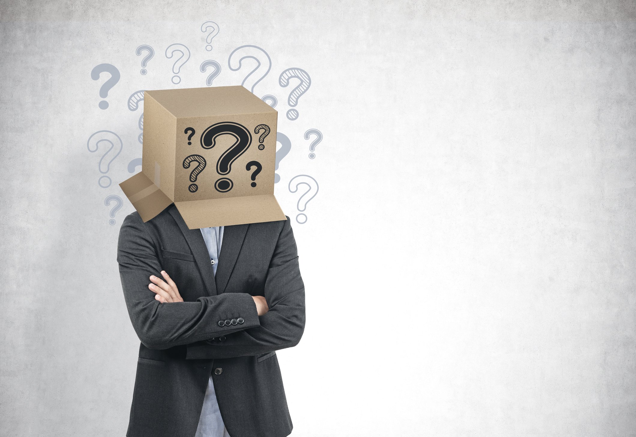 Businessman with a box on his head, question marks